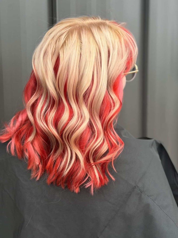 Blonde hair with red underneath, curled