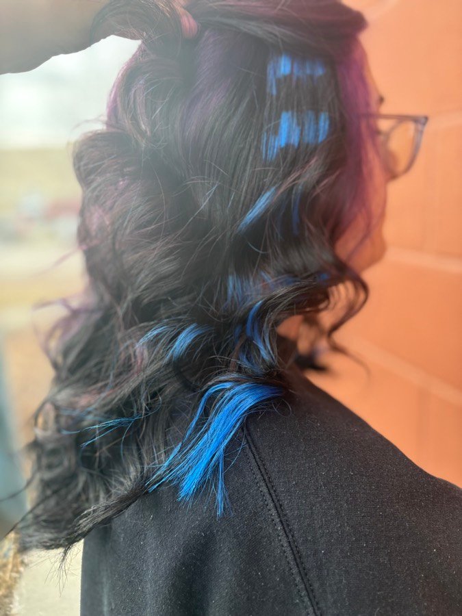 Dark hair with electric blue peekaboo streaks