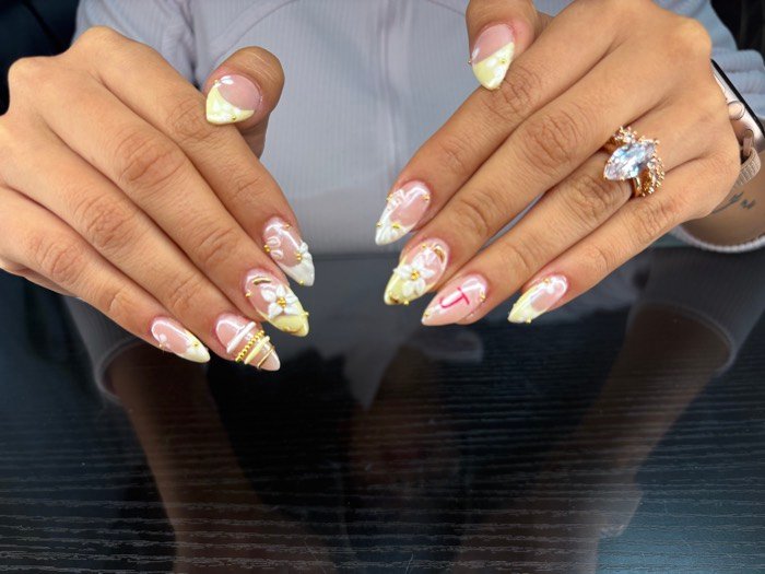 Almond nails with soft white and yellow gel art